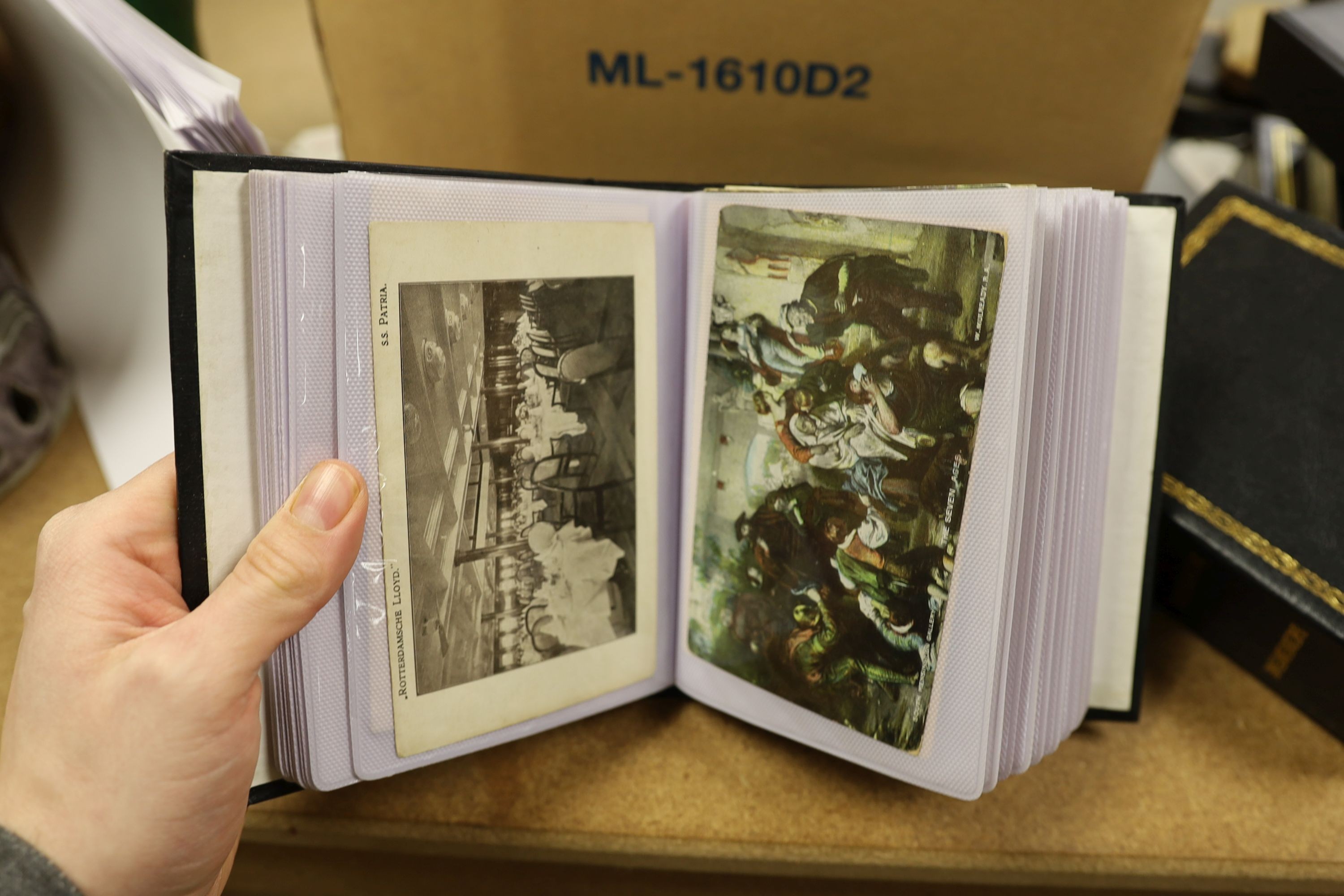 A quantity of Edwardian and later postcards, in nine modern albums